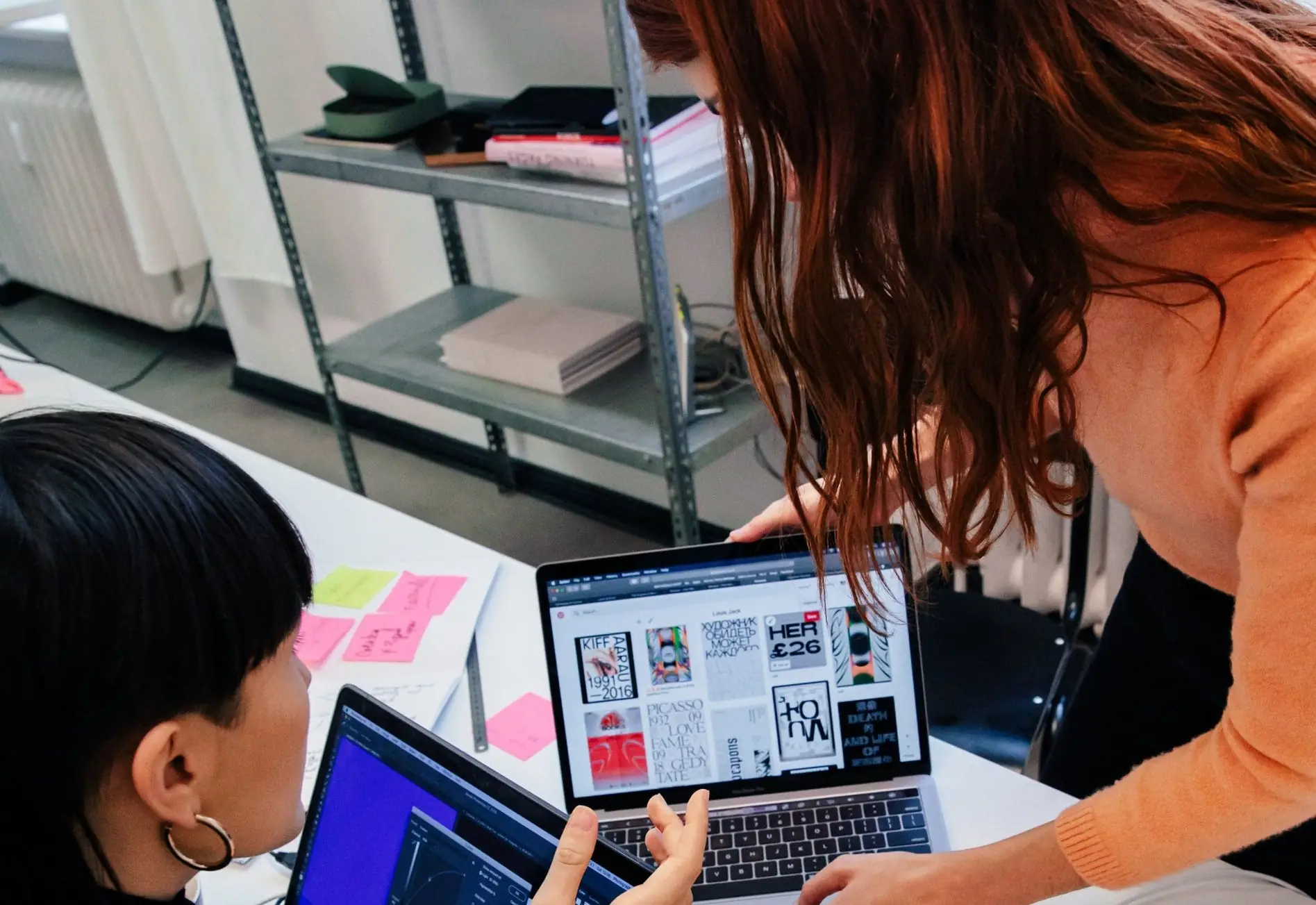 Twee collega's bekijken samen een ontwerp op een laptop